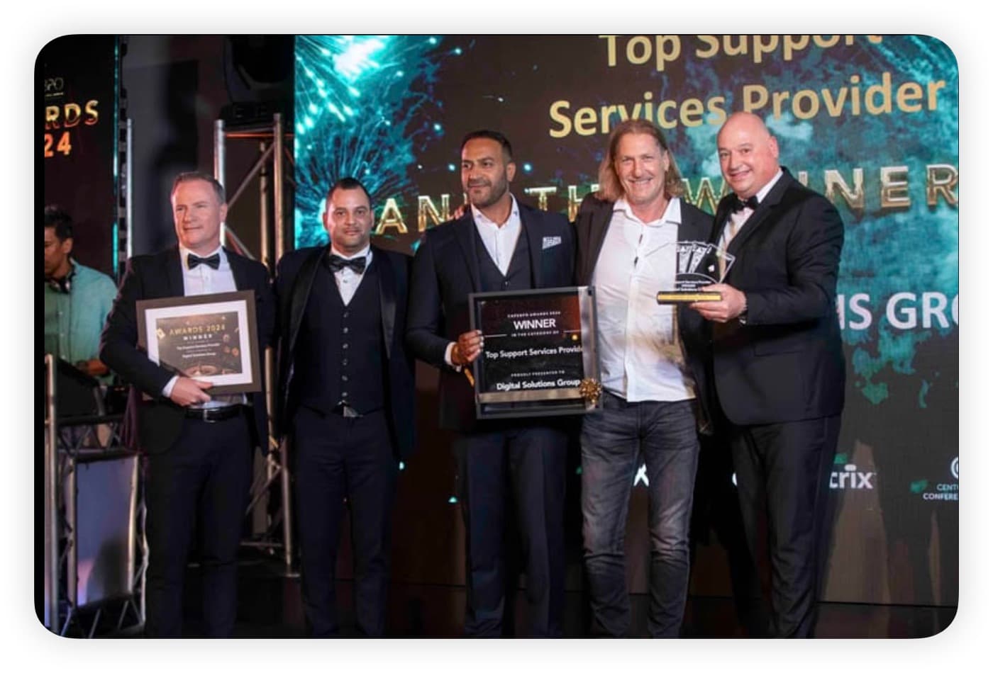 The DSG team collecting Top Support Services Provider, with the screen behind reading: and the winner is Digital Solutions Group