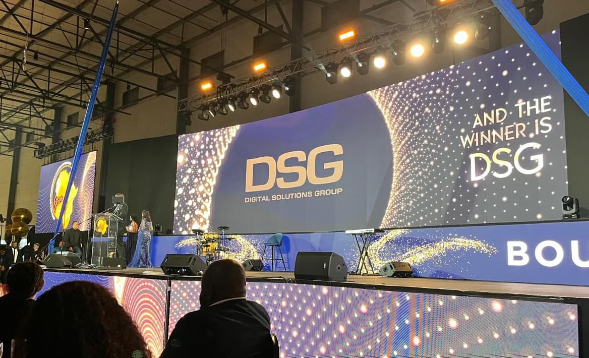 An awards ceremony screen reading: and the winner is DSG
